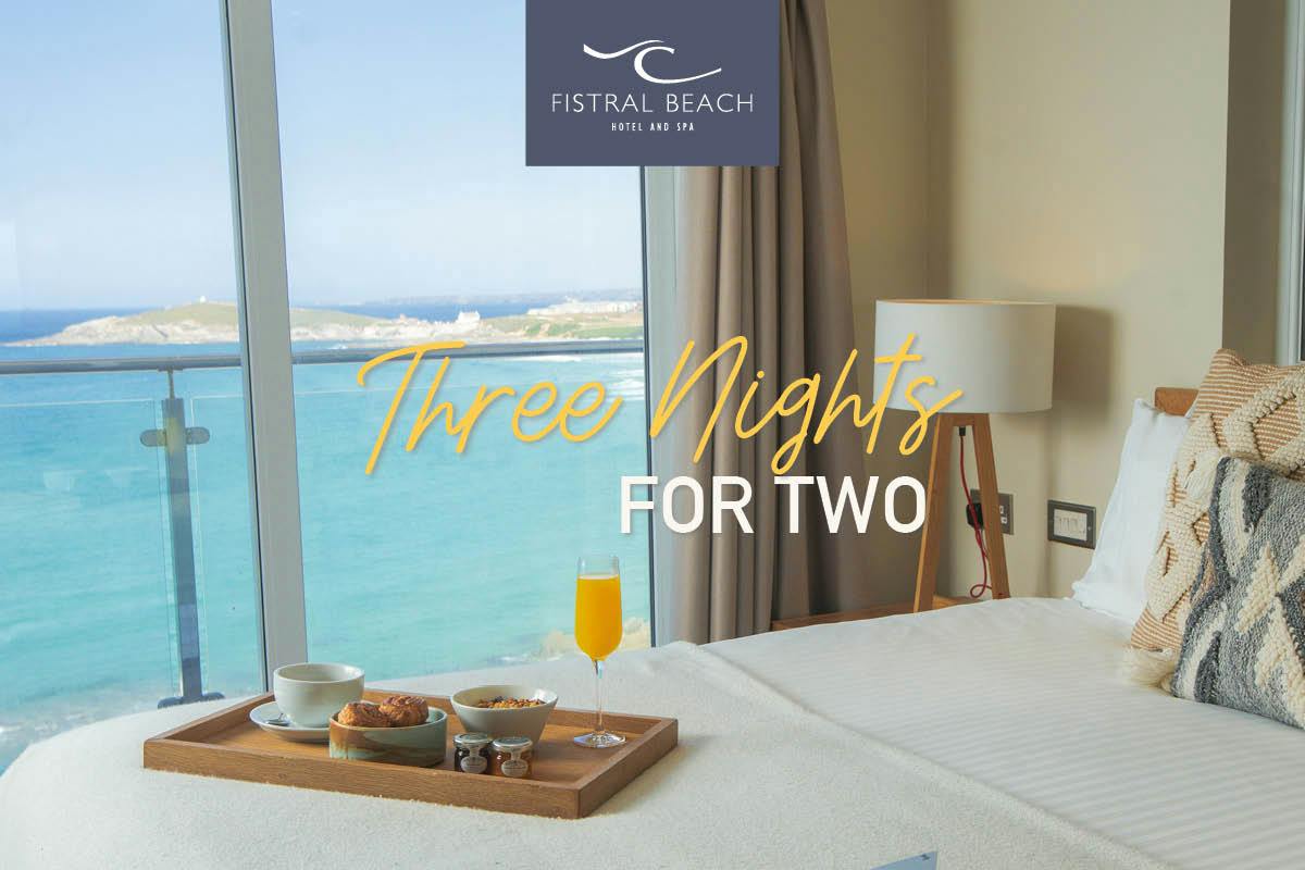 Hotel room with ocean view, breakfast tray on bed, text: "Three Nights for Two" at Fistral Beach Hotel and Spa.